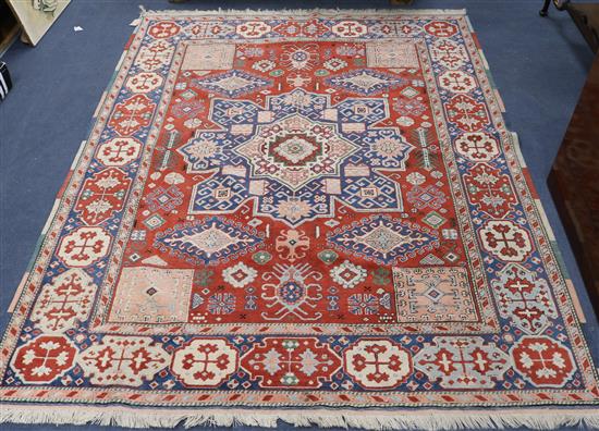 A Kazak style star medallion rug, woven on a red ground 212 x 160cm